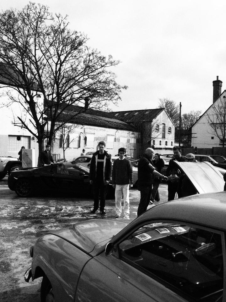 Visitors walking between the cars in the yard