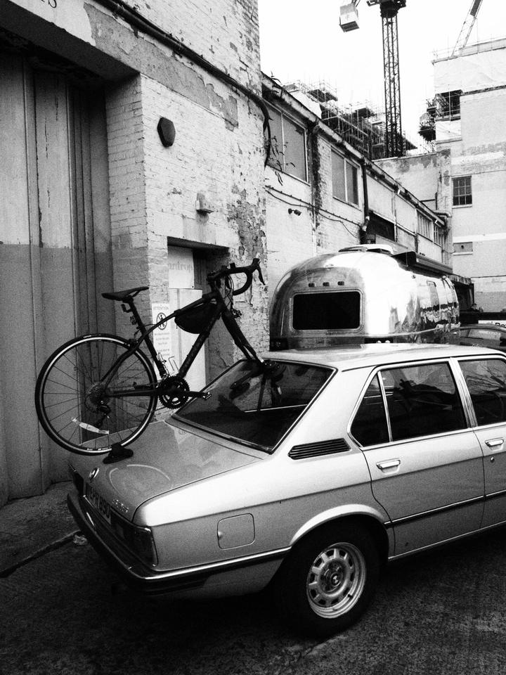 BMW E12 with a road bike on the boot, next to an Airstream