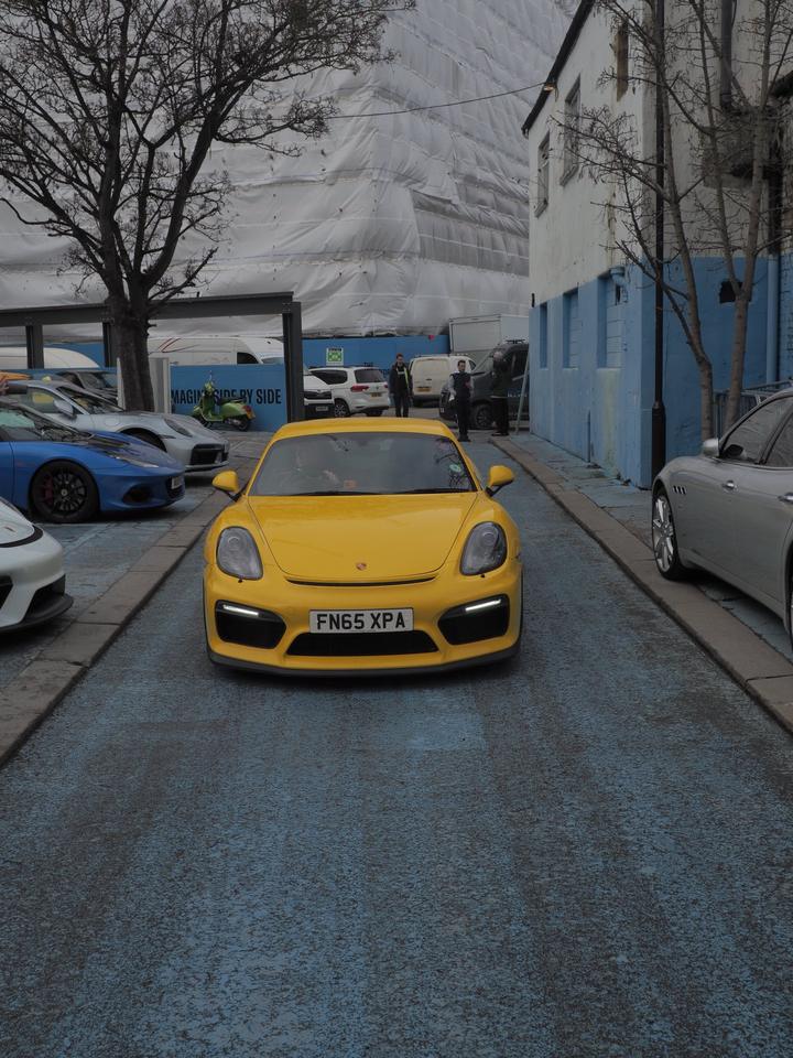 Yellow Porsche 981 GT4 rolling into the yard