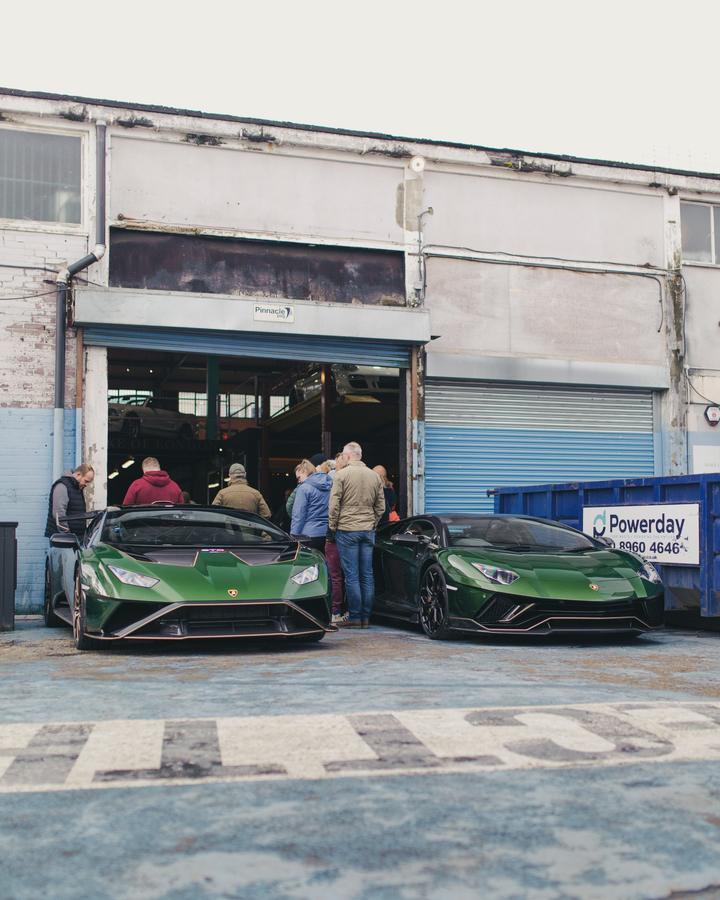 Two green Lamborghinis at the Duke of London garage door
