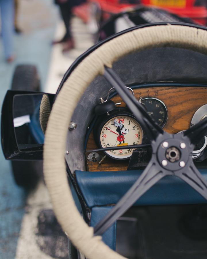 Mickey Mouse alarm clock on a vintage dashboard