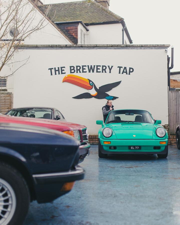 Mint green Porsche 911 under The Brewery Tap toucan