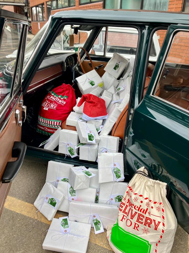 Presents piled on the Alfa Romeo's seats and spilling onto the ground